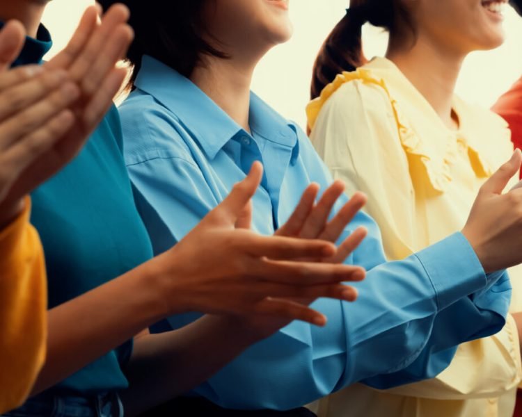 Group of startup company employee gather in line at corporate event to applaud achievement and celebrate company's success or business presentation meeting with audience in panorama banner. Synergic